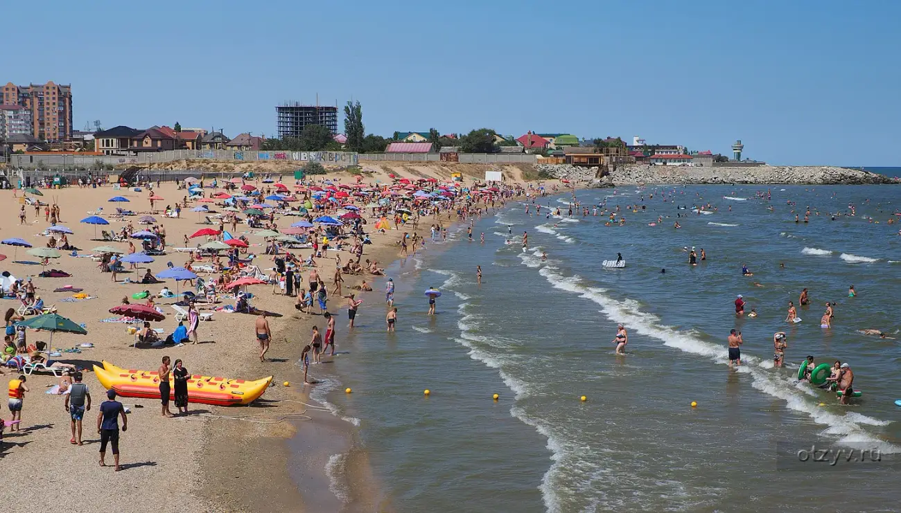 Городской пляж Каспийска с высоты: зонтики, отдыхающие и мелкая вода Каспийского моря